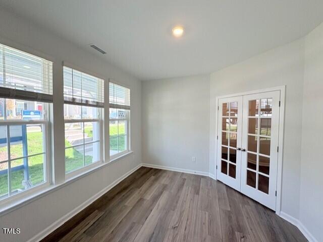 unfurnished room with french doors and wood-type flooring