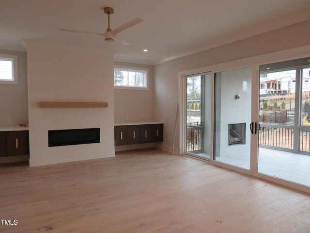 unfurnished living room with ceiling fan and light hardwood / wood-style floors