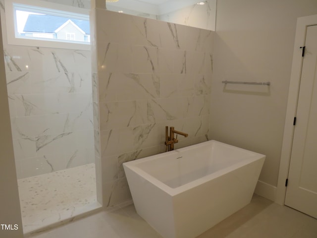 bathroom with tile patterned flooring and independent shower and bath