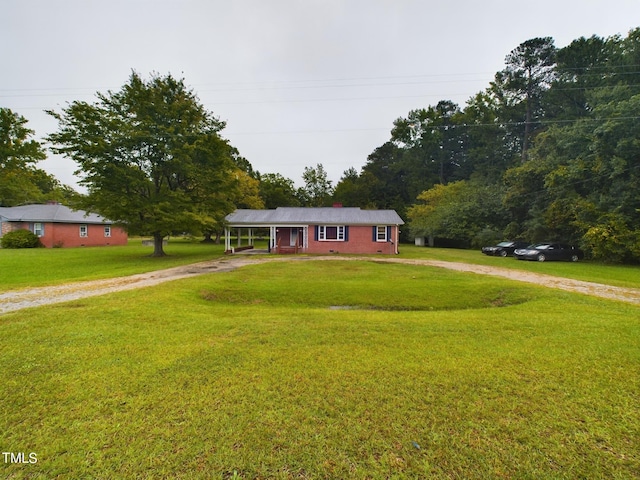 ranch-style home featuring a front yard