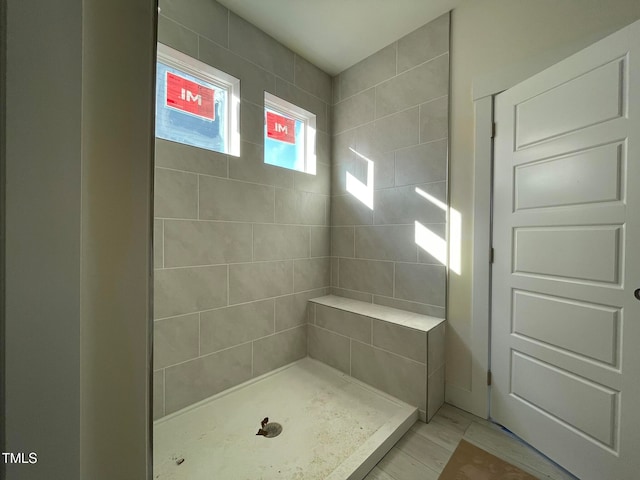 bathroom with tiled shower