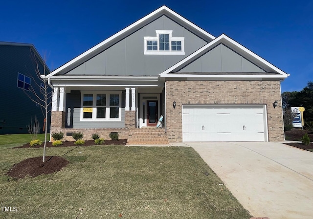 craftsman house with brick siding, board and batten siding, driveway, a front yard, and a porch
