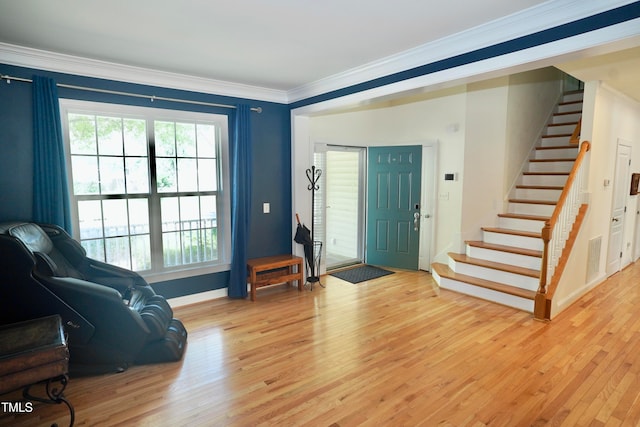 entrance foyer with crown molding and light hardwood / wood-style floors