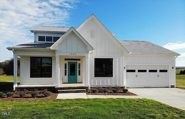 view of front of property featuring a garage and a front lawn