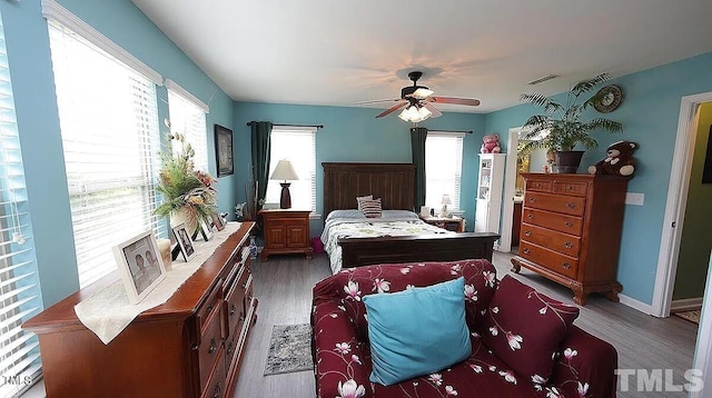 bedroom with ceiling fan and dark hardwood / wood-style flooring