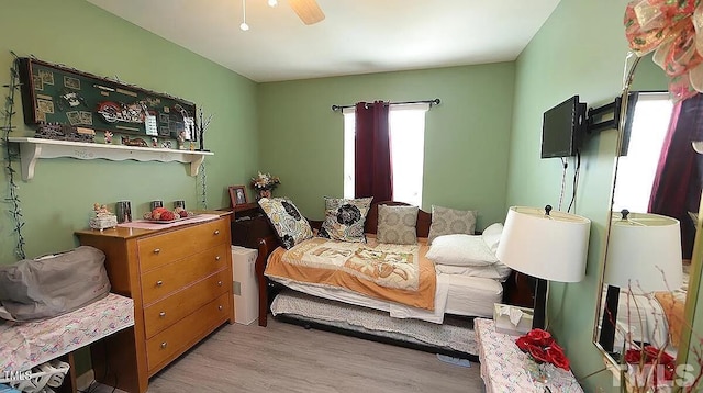 bedroom featuring light wood-type flooring and ceiling fan