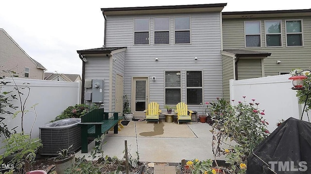 rear view of house with central AC unit and a patio area