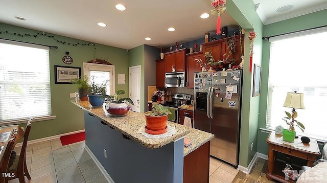 kitchen with backsplash, light tile patterned flooring, stainless steel appliances, and a breakfast bar