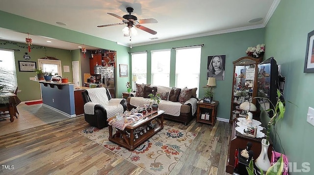 living room with ornamental molding, ceiling fan, and dark hardwood / wood-style floors