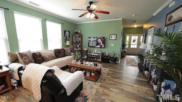 living room with crown molding, ceiling fan, and hardwood / wood-style flooring