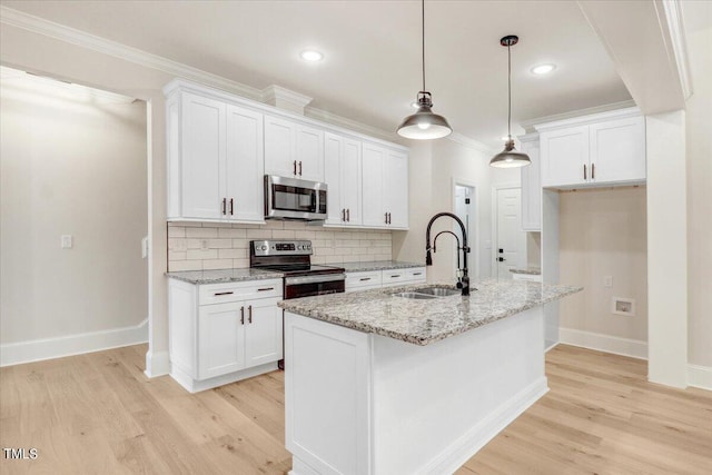 kitchen with appliances with stainless steel finishes, white cabinetry, and sink