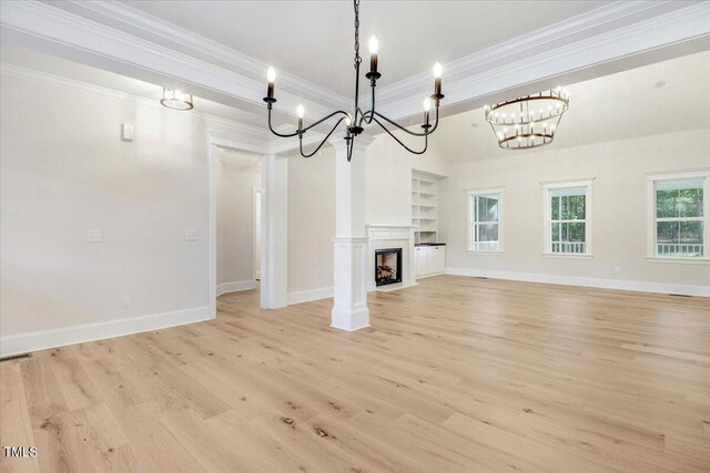 unfurnished living room featuring light hardwood / wood-style floors, ornamental molding, an inviting chandelier, and built in features