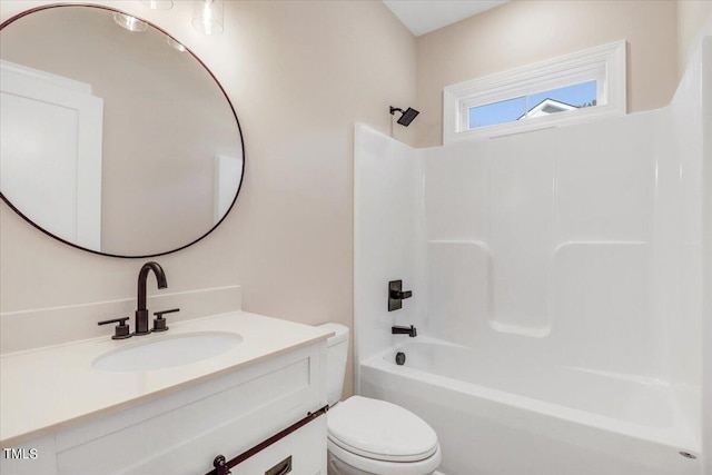 full bathroom featuring washtub / shower combination, vanity, and toilet