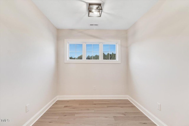 spare room featuring light hardwood / wood-style flooring