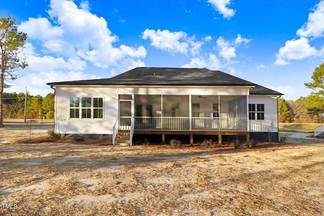 rear view of house featuring a sunroom