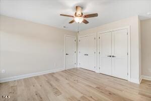 unfurnished bedroom featuring ceiling fan and light wood-type flooring