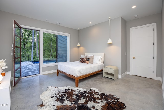 bedroom featuring access to exterior and concrete floors