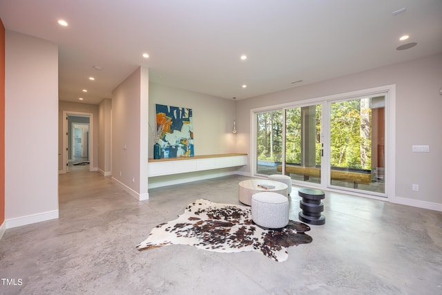 living area featuring concrete floors