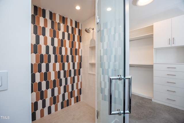 bathroom featuring radiator and a shower with door