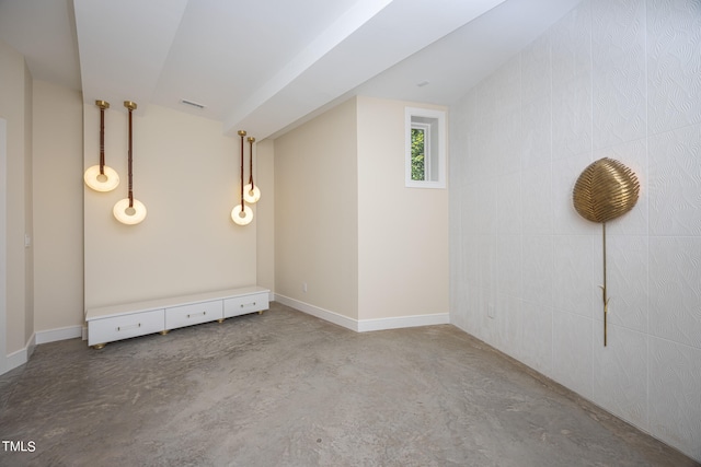 unfurnished room featuring concrete flooring and vaulted ceiling