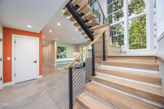 staircase featuring concrete floors