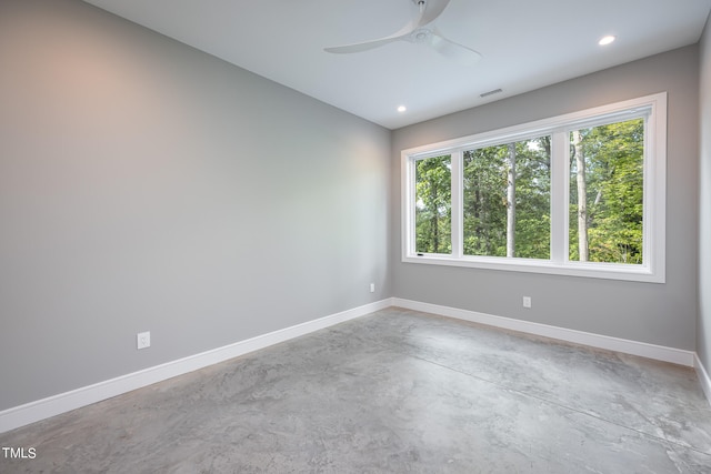 unfurnished room with concrete floors and ceiling fan