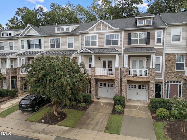 townhome / multi-family property featuring a balcony and a garage