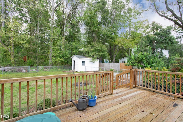 wooden terrace with a yard and a shed