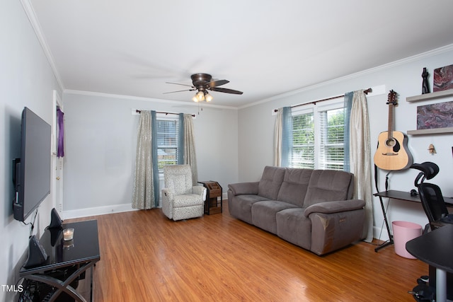 living room featuring wood-type flooring, ornamental molding, and ceiling fan