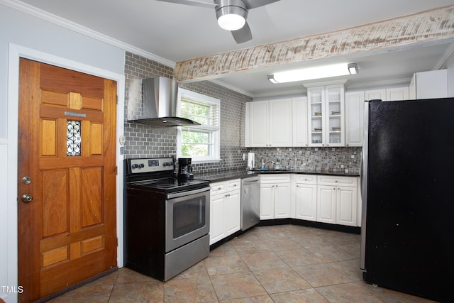 kitchen with sink, white cabinetry, wall chimney range hood, decorative backsplash, and stainless steel appliances