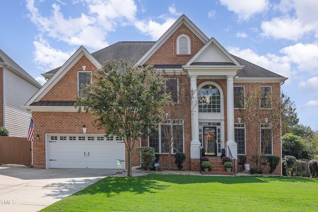 view of front of house with a front yard and a garage