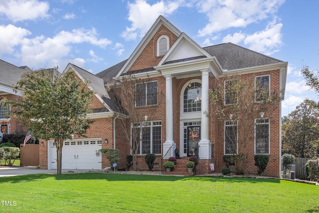 view of front of home featuring a front yard and a garage