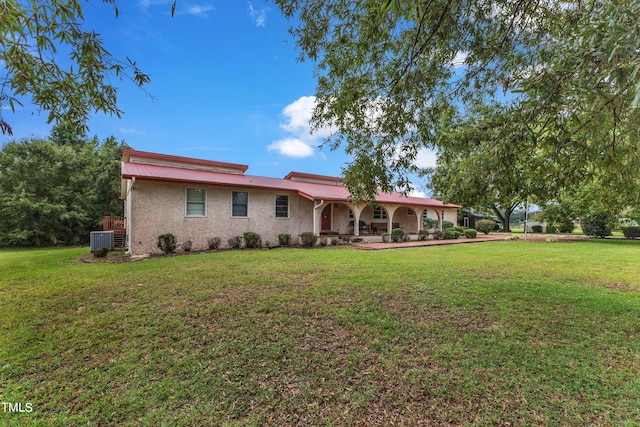 rear view of property with a lawn and central AC unit