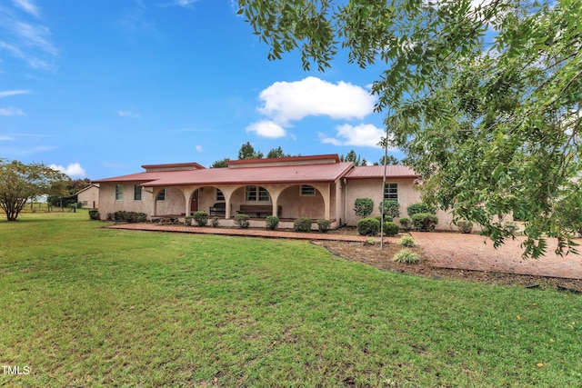 rear view of property with a lawn