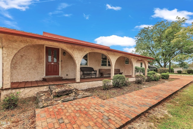 rear view of property with a porch