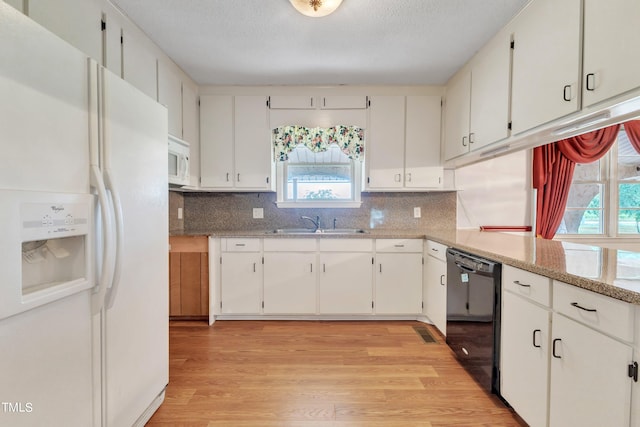 kitchen featuring light hardwood / wood-style floors, a healthy amount of sunlight, white appliances, and white cabinetry