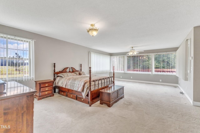 carpeted bedroom with a textured ceiling and ceiling fan