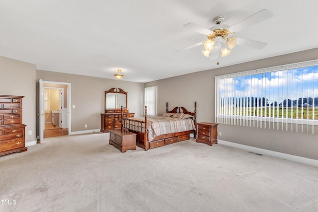 carpeted bedroom with ceiling fan and connected bathroom