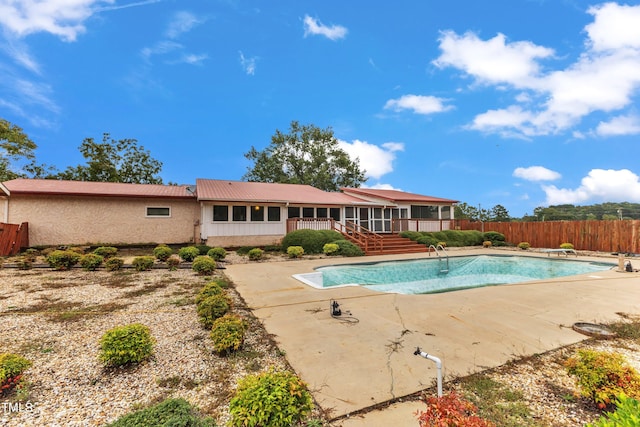 view of pool featuring a patio and a diving board