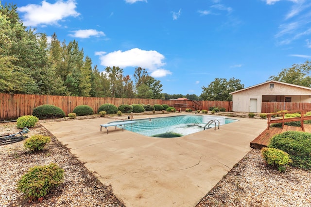 view of swimming pool with a patio and a diving board