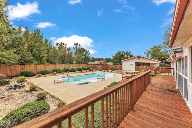 view of swimming pool with a patio area and an outbuilding