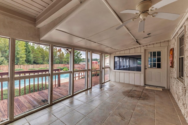 unfurnished sunroom featuring lofted ceiling and ceiling fan