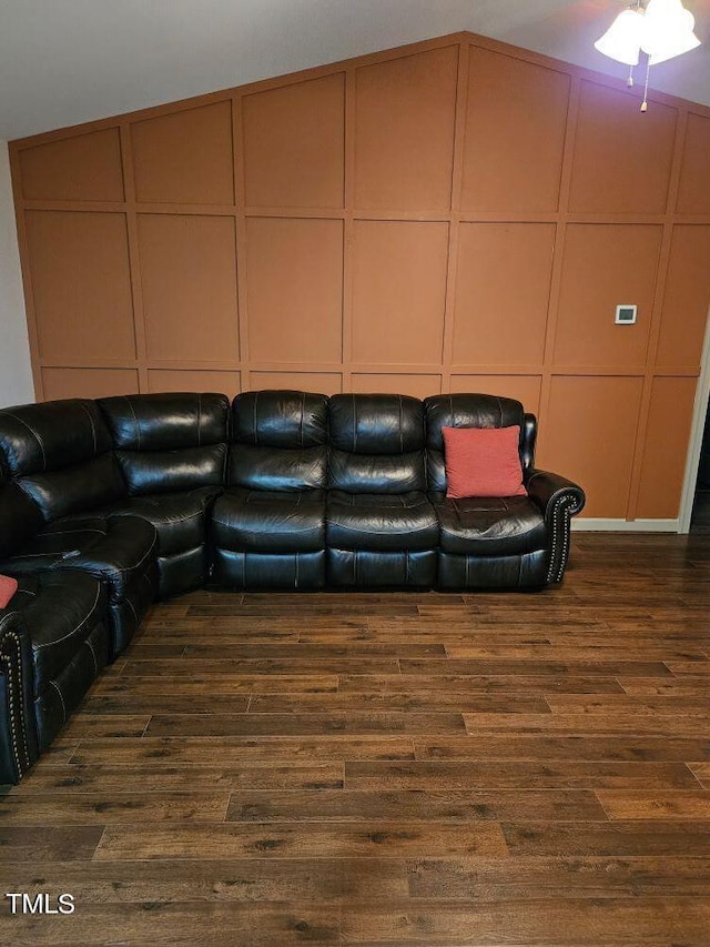 living room with lofted ceiling and dark wood-type flooring