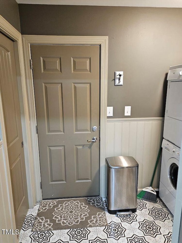 laundry area featuring stacked washing maching and dryer