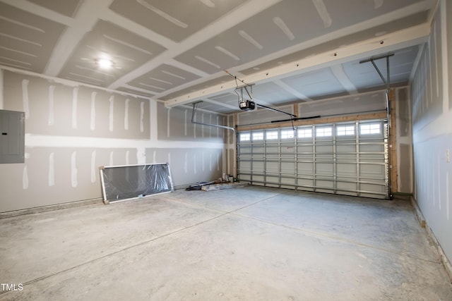 garage with a garage door opener and electric panel