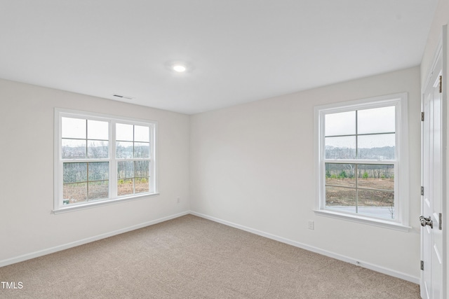 empty room with light colored carpet