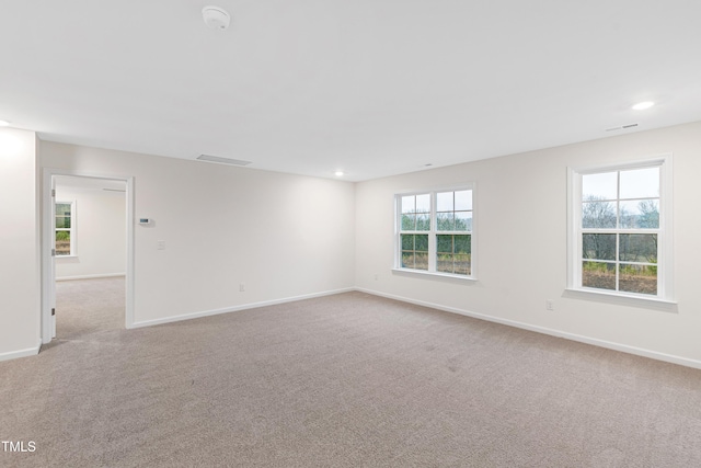 spare room featuring light colored carpet