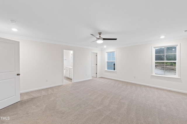 carpeted empty room with ceiling fan and ornamental molding