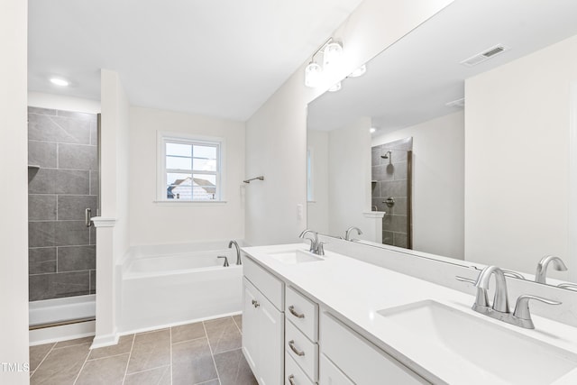 bathroom featuring tile patterned flooring, vanity, and plus walk in shower
