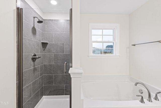 bathroom with separate shower and tub